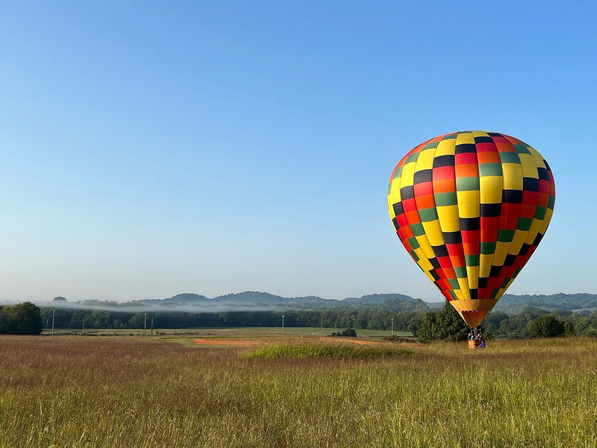 A hot air balloon sitting in a field