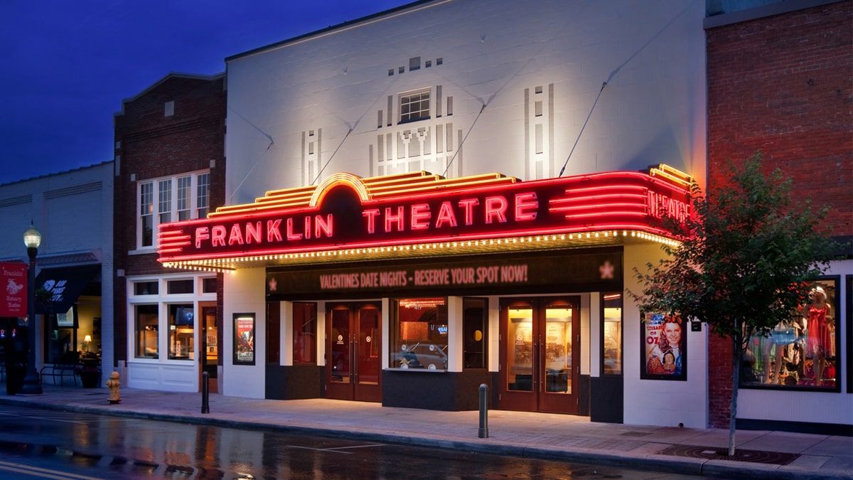 The Franklin Theatre building at night with neon lights