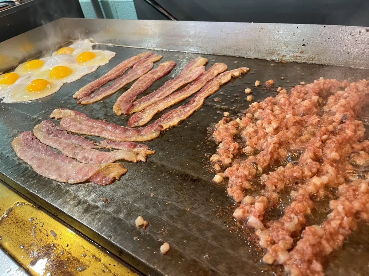 hash, bacon, and fried eggs on a flatop at Just Bee Diner in Jonesborough TN