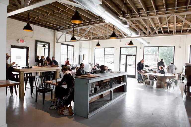 Airy and spacious coffee shop in Knoxville, TN with people working on their laptops.