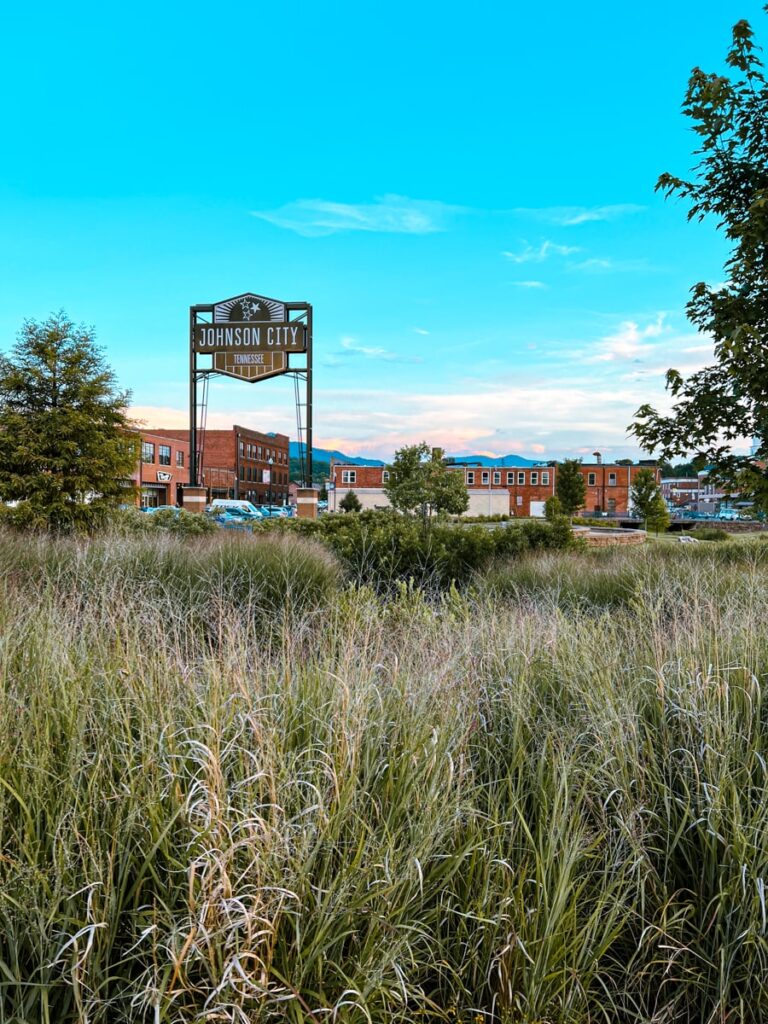downtown johnson city with large sign and blue skies