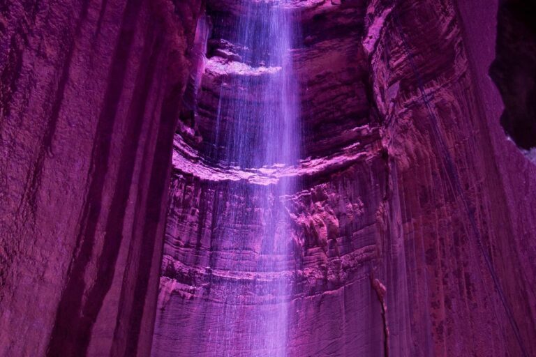 Ruby Falls in Chattanooga illuminated in purple light.