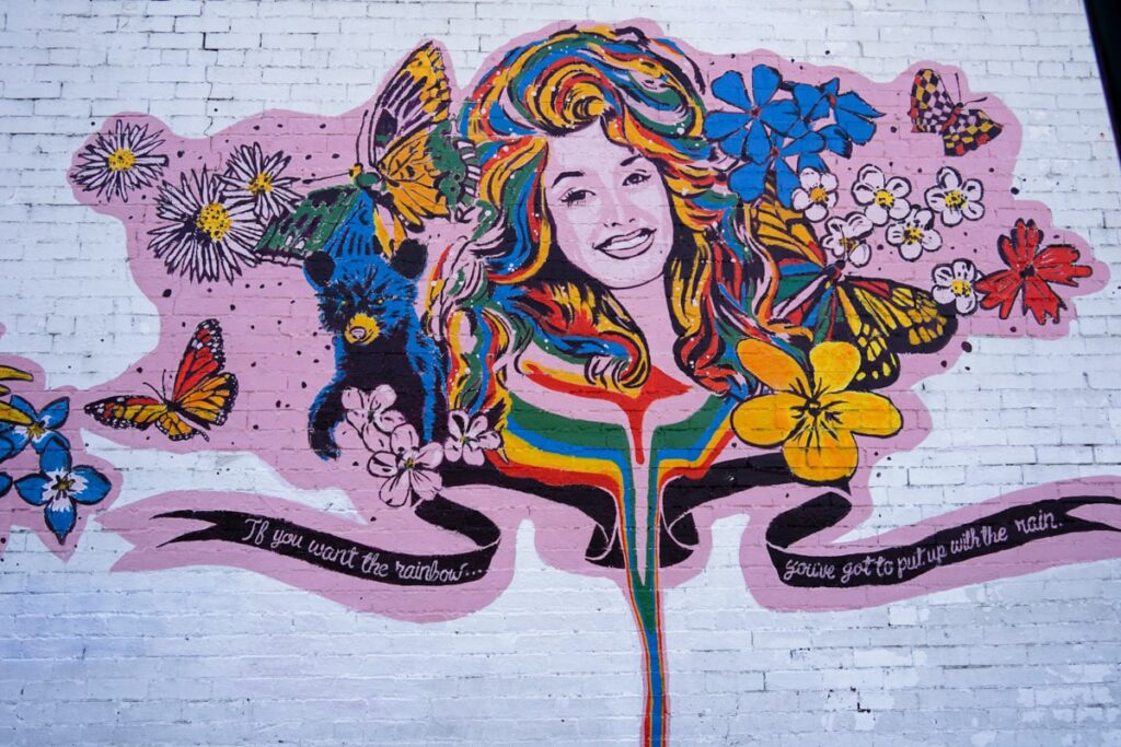 Dolly Parton Wall Mural saying "If you want the rainbow, you've got to put up with the rain."