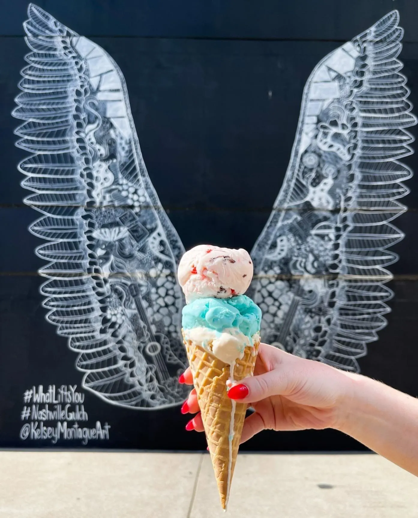 ice cream in front of the wing mural in downtown nashville at the Gulch