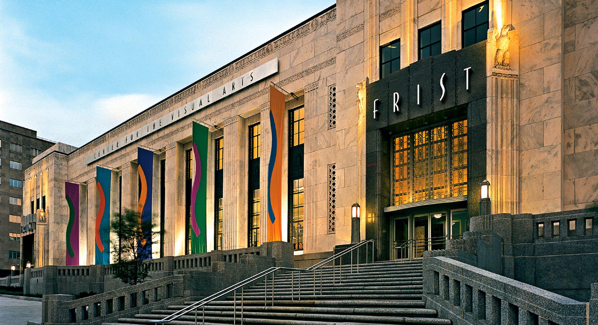 The Frist art museum building with colorful flags and warm lighting