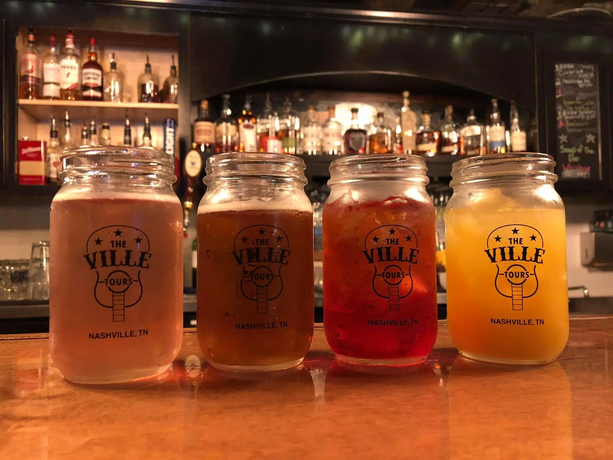 bar drinks and beer in The Ville Tours cups sitting on a bar in nashville tn 