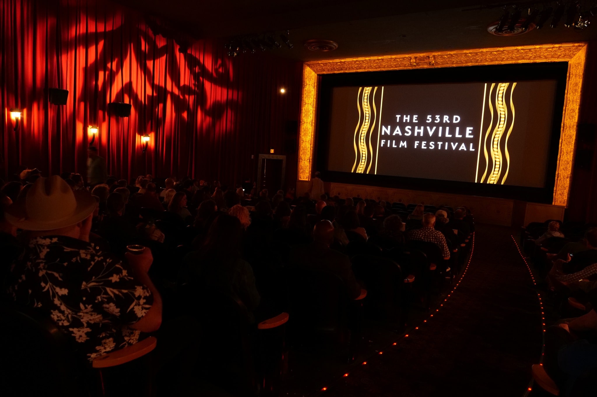 the 2022/53rd nashville film festival with people watching a tv screen in a dark theatre