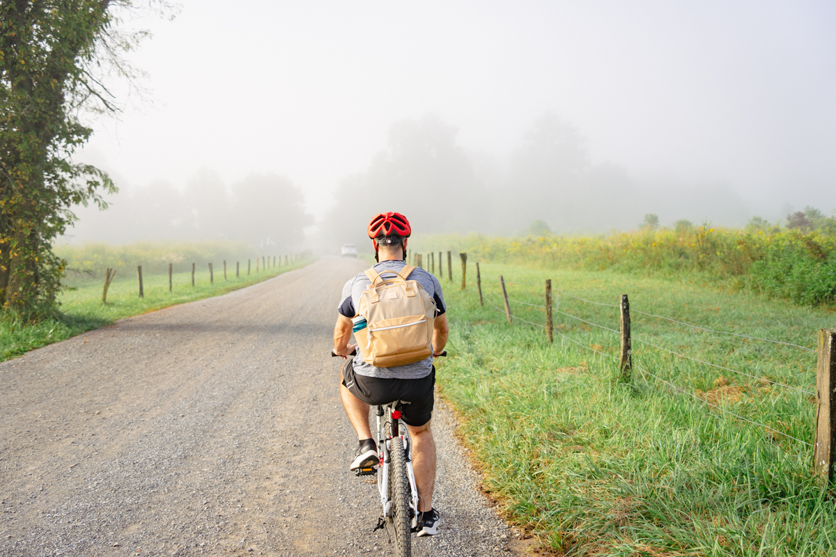 man biking on Cades Cove loop with red helmet in the Smoky Mountains National Park tn 