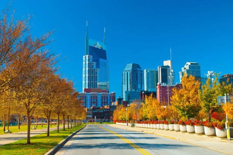downtown nashville in the fall with fall foliage and the skyline buidlings in the background