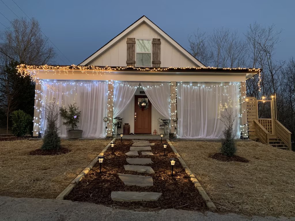 cozy cabin with wrap around porch and twinkling lights in nashville tn 