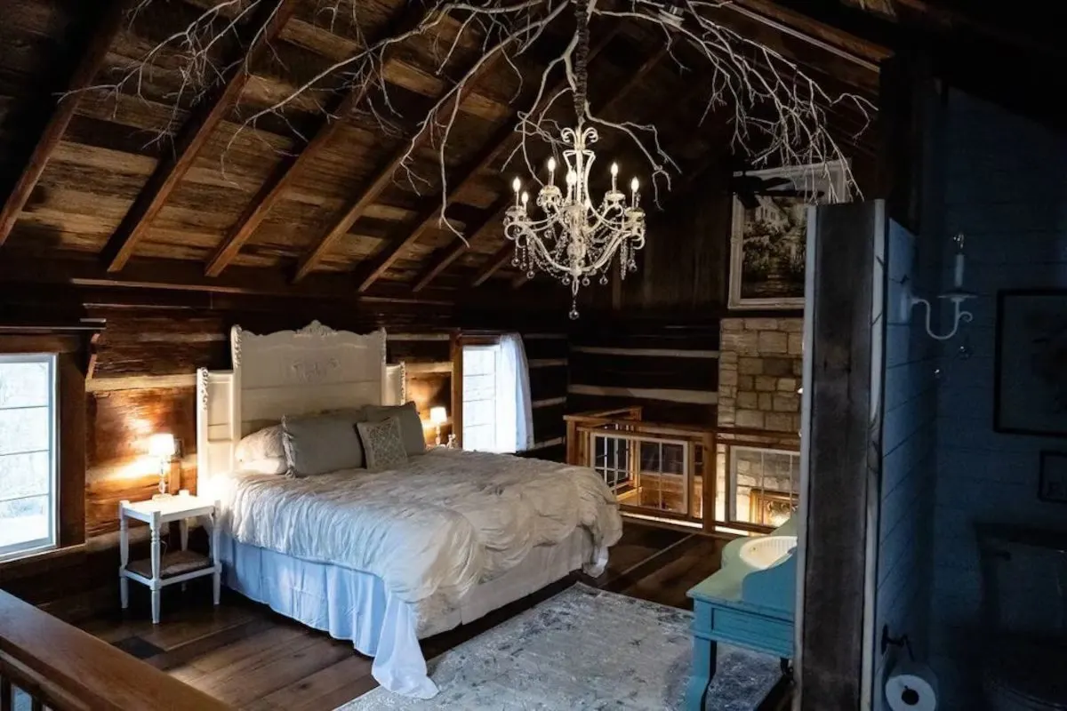 bedroom in the historic log cabin near nashville with comfortable bedding and antique furniture 