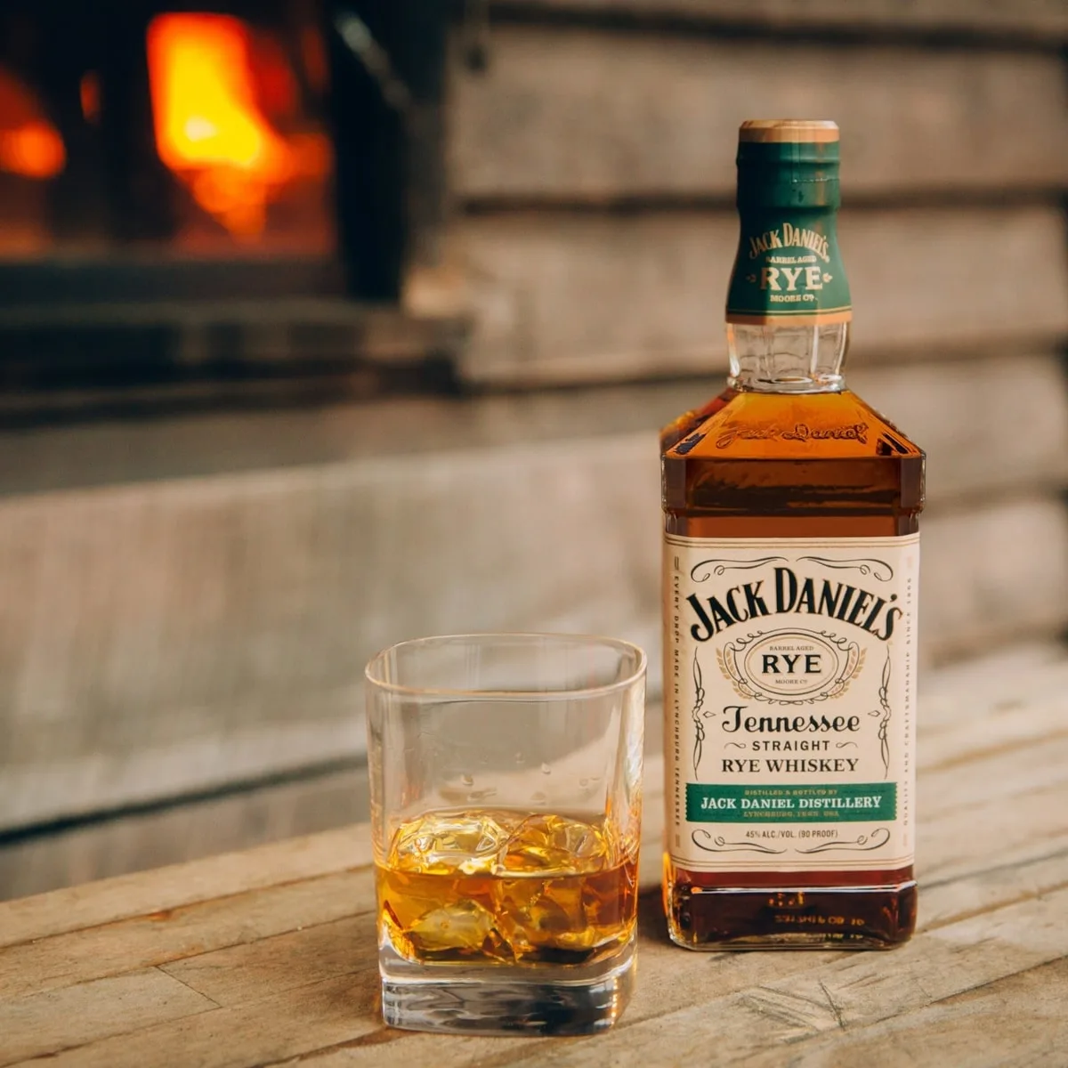 Jack Daniels bourbon bottle with broubon neat in front of a fireplace at Jack Daniels Distillery in Lynchburg