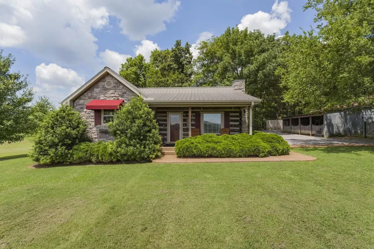 log cabin with trees and bushes and small front porch near murfreesboro tn 