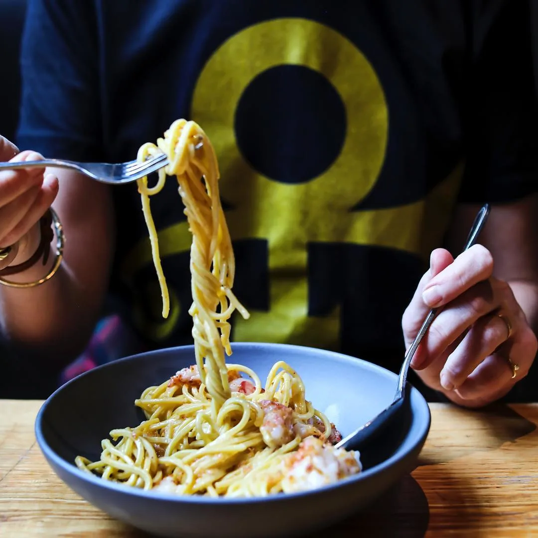 person eating pasta at rolf and daughters restaurants in nashville 