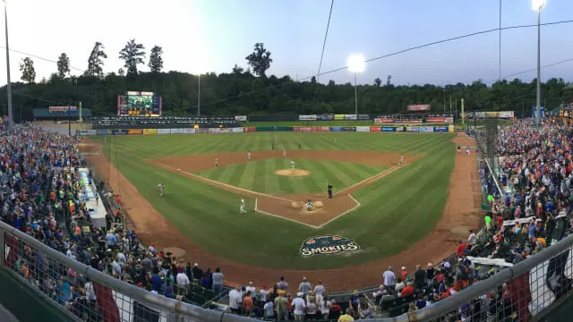 tennessee smokies baseball milb stadium with players and smoky mountains