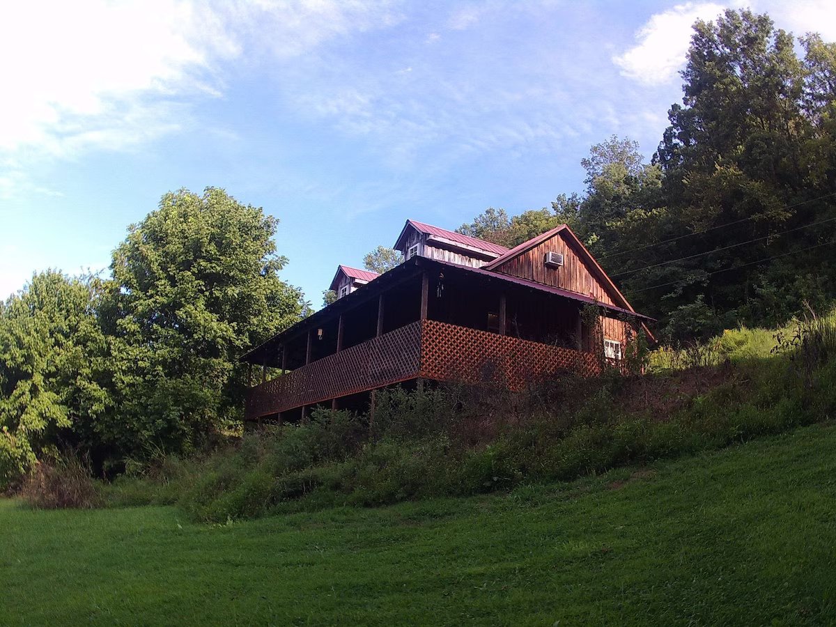 view of the exterior of the cabin with wood siding and trees in cookeville tn 