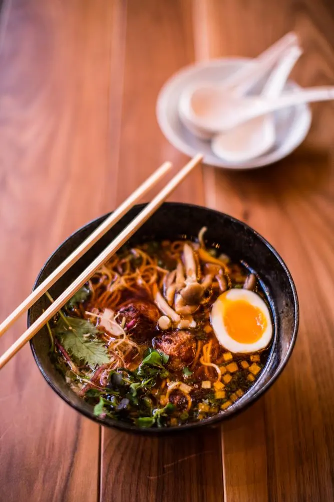 bowl of ramen with egg and chopsticks at two ten jack restaurant in nashville 