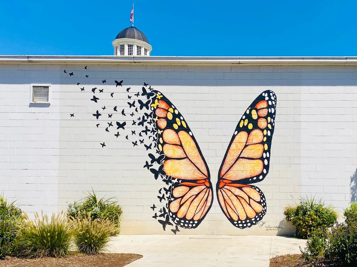 wings of wander butterfly mural in sevierville with blue skies 