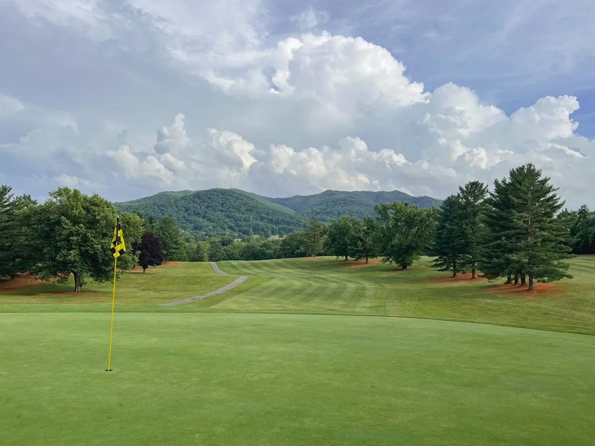 view from the golf course with flag and mountains in the background at pine oaks golf course in johnson city tn 