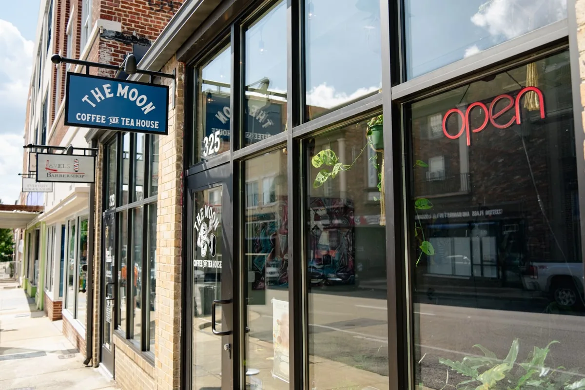 the moon coffee and tea shop entrance with sign and plants through the glass in downtown johnson city tn 