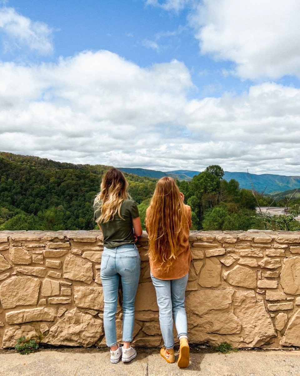 two sisters overlooking the tennessee mountains from an overlook near Asheville, NC 