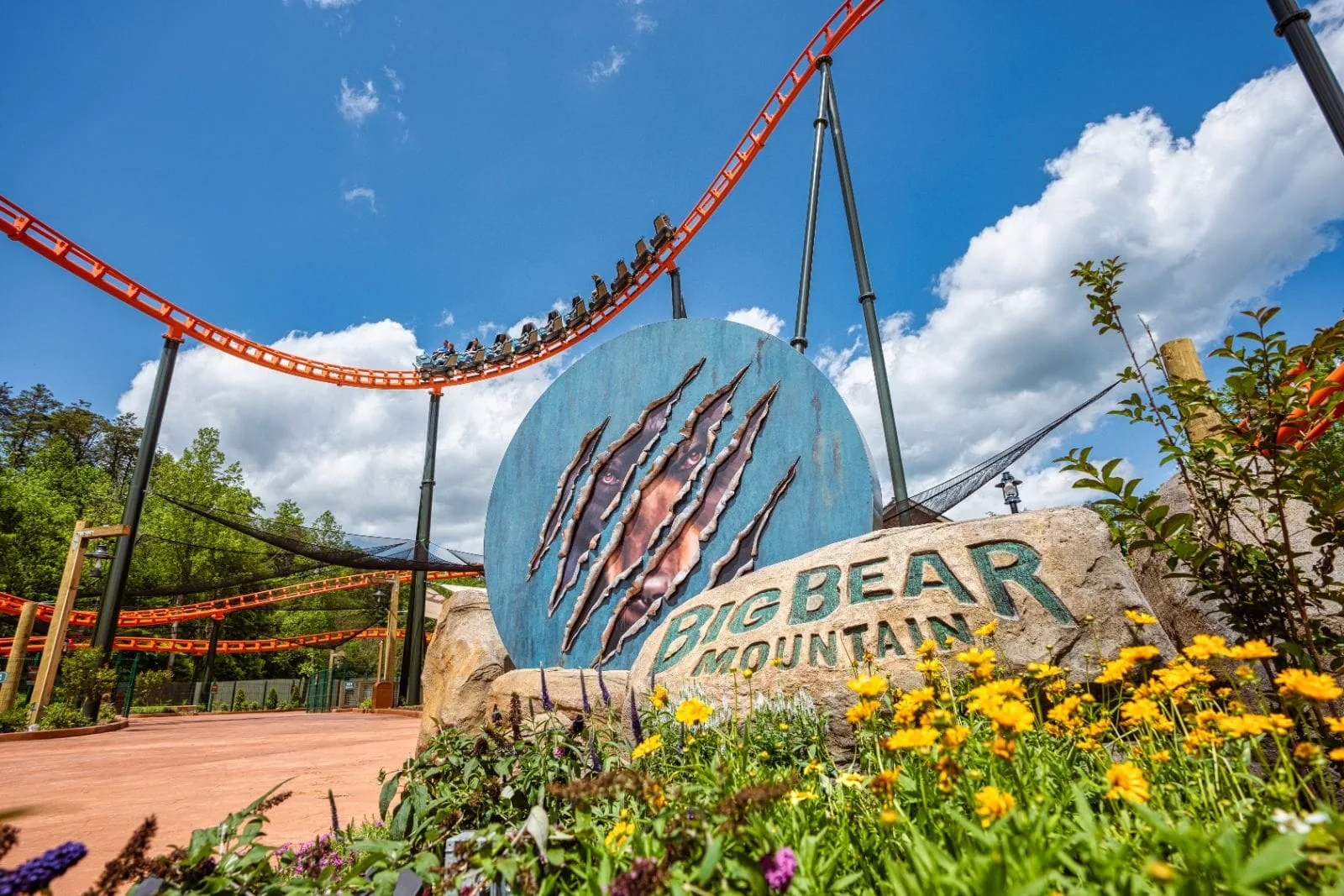 big bear mountain roller coaster sign with roller coaster in the background at dollywood theme park