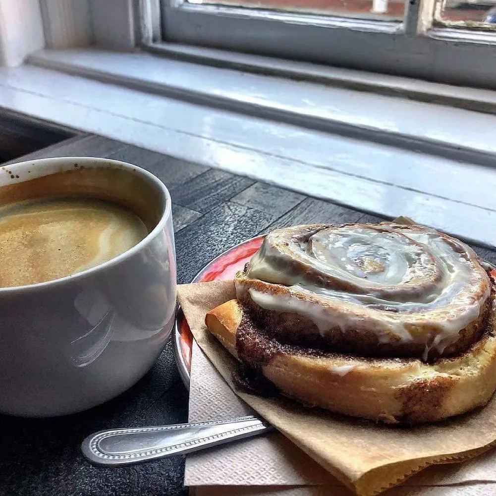 a hot cappuccino and a large gooey cinnamon roll at coffee at the kyle in rogersville tn 