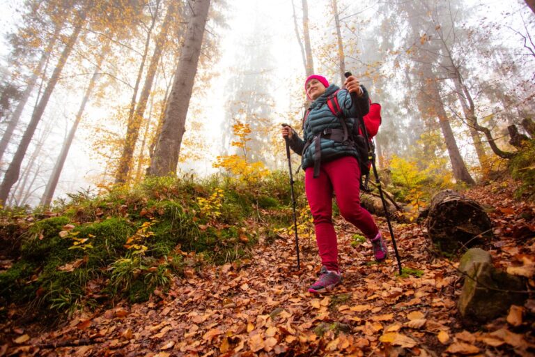 woman hiking in the fall season with fall foliage