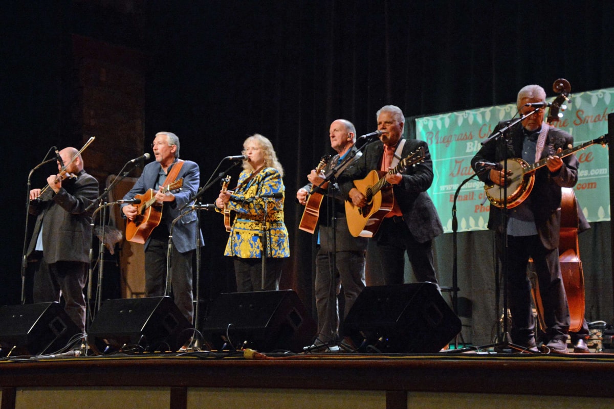 bluegrass band playing christmas music on stage at the bluegrass christmas in the smokies event