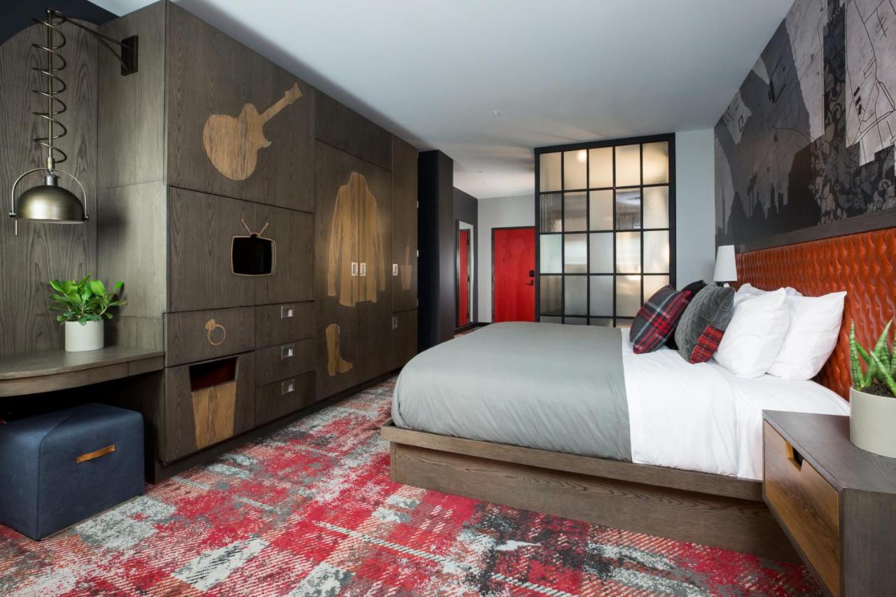 modern hotel room with queen bed and comfortable bedding at the bobby hotel in nashville