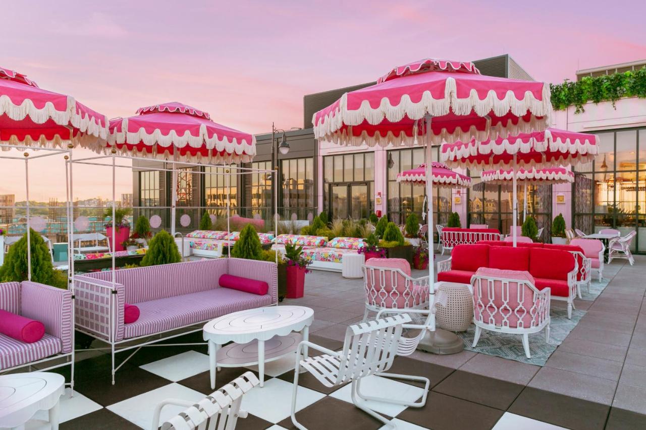 a rooftop patio with pink decor and furniture at the graduate hotel in nashville tn 