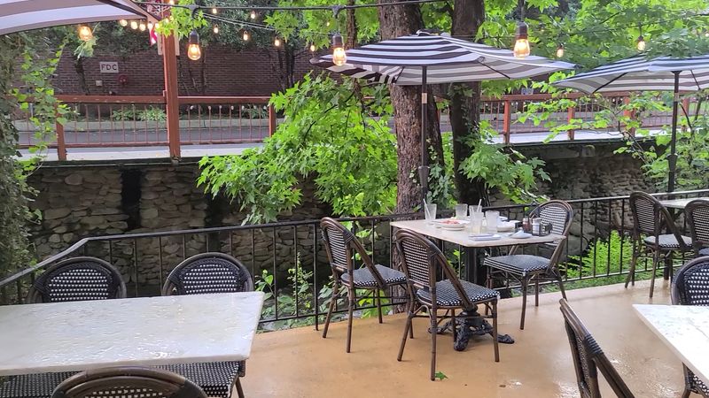 Creekside seating gives this spot more charm than you expect