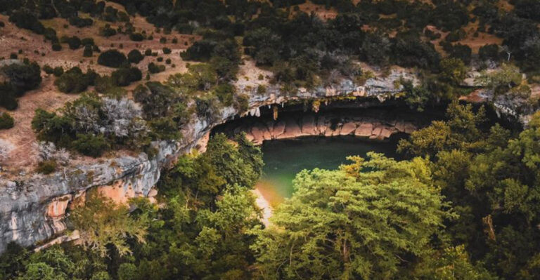 This Surreal Texas Grotto Looks Like a Hidden Oasis with Emerald Water and a 50-Foot Waterfall