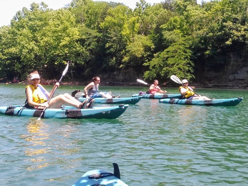 Paddleboarding And Kayaking On Calm Quarry Waters Paddleboarding And Kayaking On Calm Quarry Waters