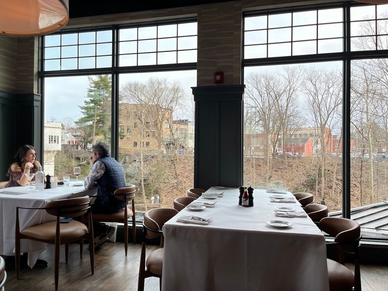 A dining room with a waterfall view A dining room with a waterfall view