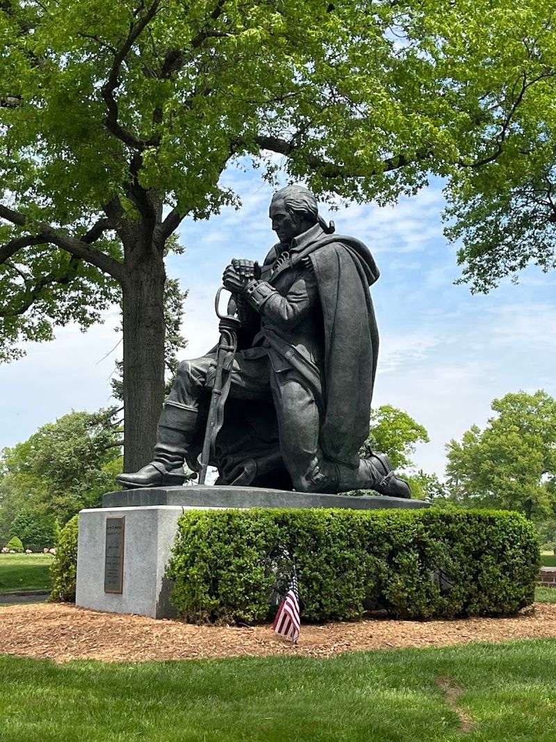 A monumental kneeling George Washington statue anchors the landscape A monumental kneeling George Washington statue anchors the landscape