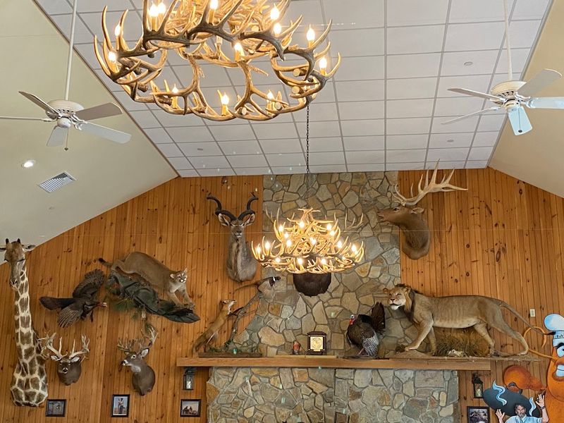 A towering stone fireplace anchors the rustic lodge-like dining room