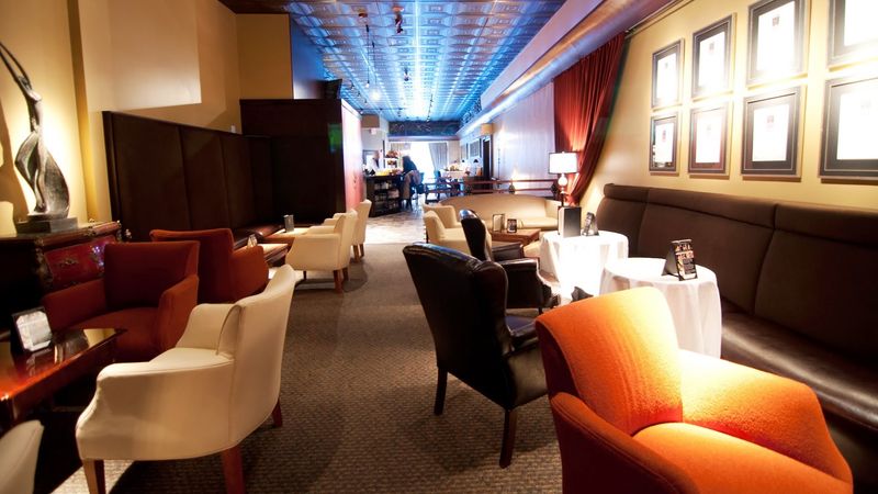 Inside the Space: Low Lights, Deep Couches, and a Cigar Lounge Below Inside the Space: Low Lights, Deep Couches, and a Cigar Lounge Below