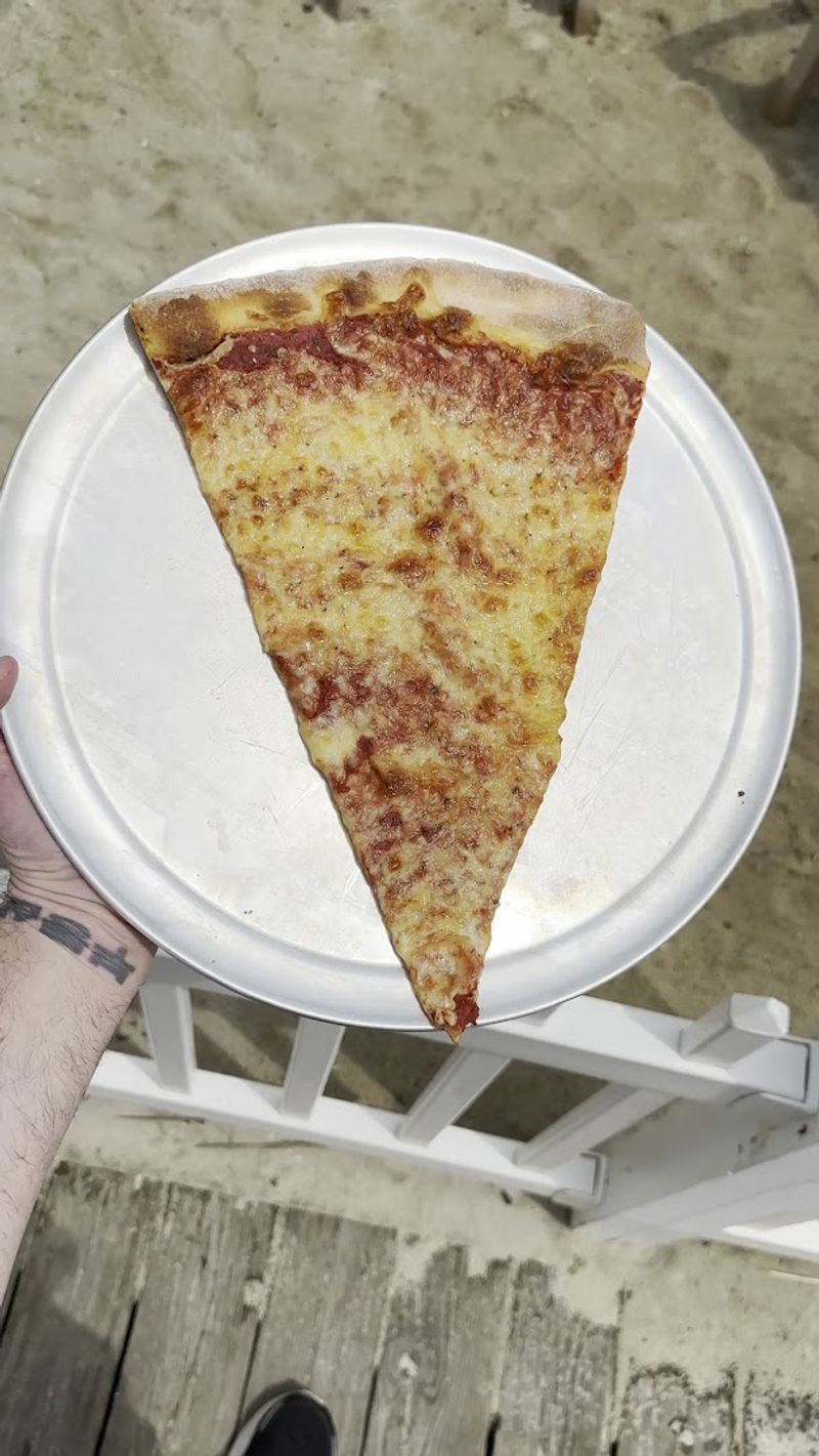 The Famous Jumbo Slice Cut From a Massive 27-Inch Pizza The Famous Jumbo Slice Cut From a Massive 27-Inch Pizza