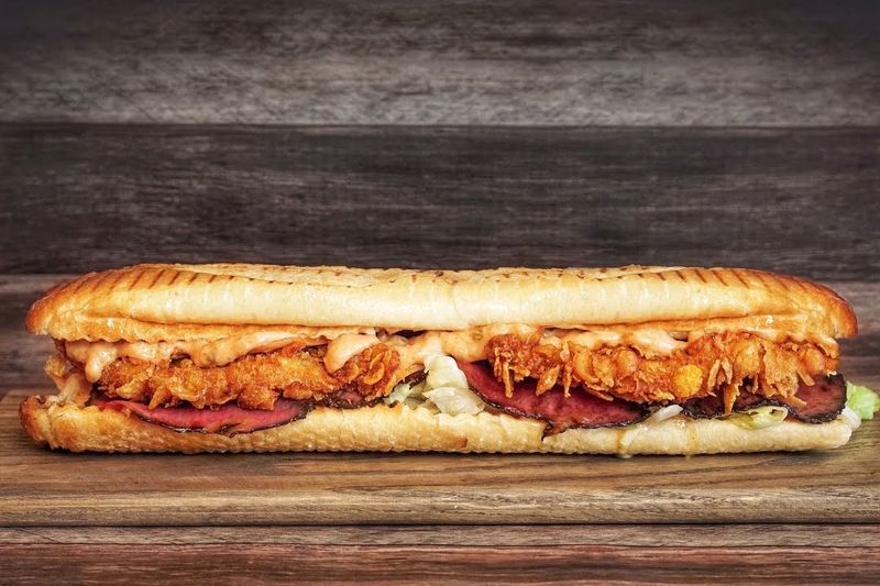 The Holy Toasty Piles Cornflake Chicken and Pastrami Onto One Baguette The Holy Toasty Piles Cornflake Chicken and Pastrami Onto One Baguette