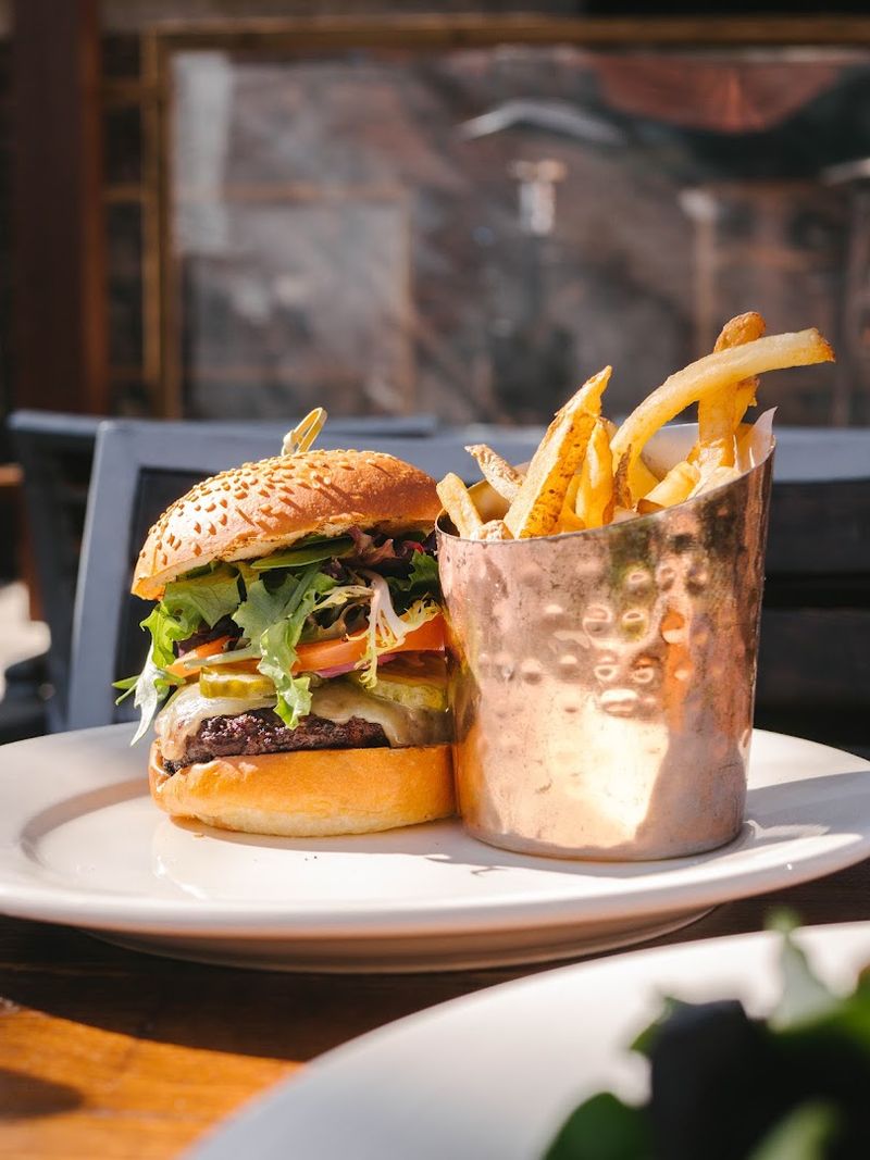 The Hutton Burger Piles Irish Cheddar and Smoked Bacon Jam Onto Every Bite The Hutton Burger Piles Irish Cheddar and Smoked Bacon Jam Onto Every Bite