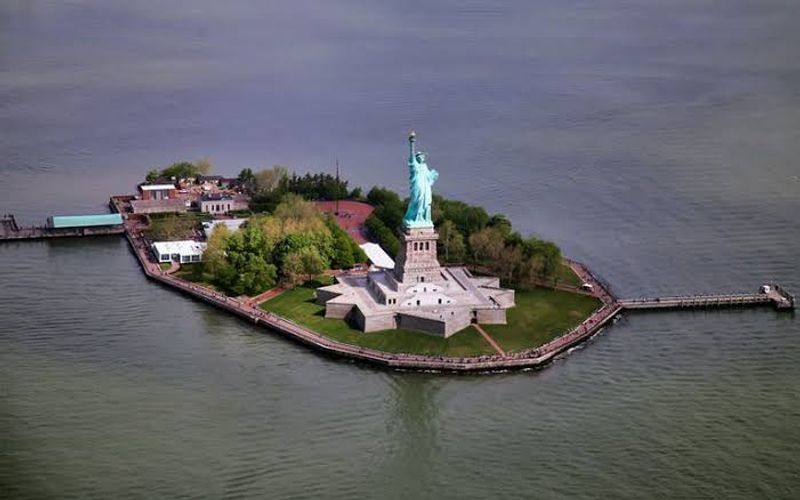 The Statue of Liberty and Ellis Island Sit Right Across the Water