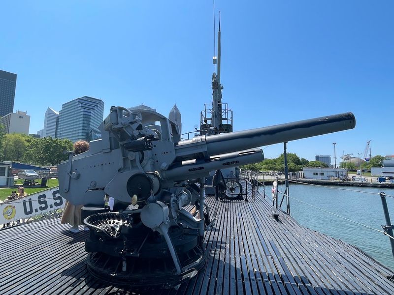 The deck, guns, and lakeside setting