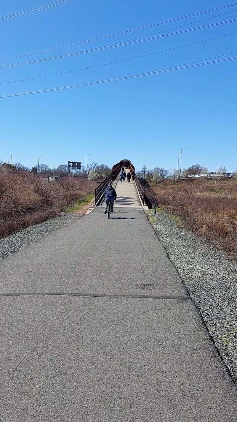 The wide paved path welcomes walkers joggers cyclists and families