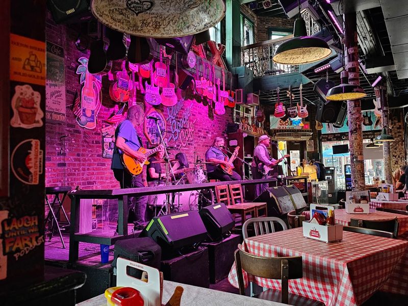 A Collection of 200 Signed Guitars Hanging From the Ceiling A Collection of 200 Signed Guitars Hanging From the Ceiling