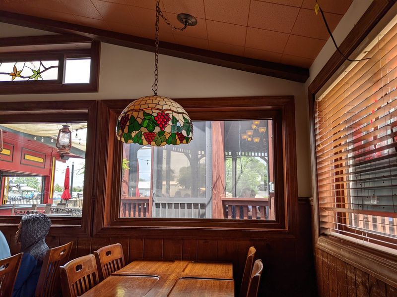 Stained glass and warm light soften the saloon mood Stained glass and warm light soften the saloon mood
