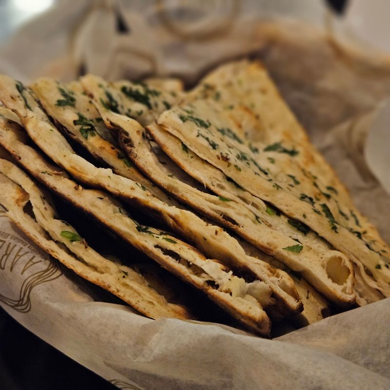 Tandoor-Baked Garlic Naan Steals the Spotlight at Every Table
