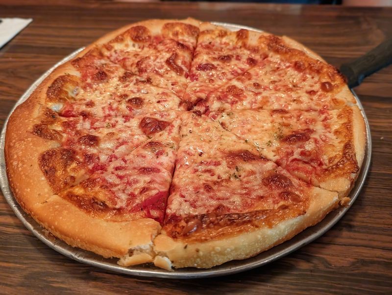 The Thin-Crust Pizza Has Been Drawing Locals Back Since 1927 The Thin-Crust Pizza Has Been Drawing Locals Back Since 1927