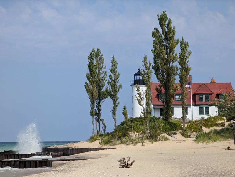 A White Lighthouse Against Blue Water A White Lighthouse Against Blue Water
