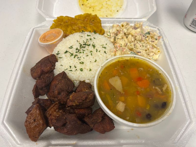 Rice, Plantains, And Macaroni Salad Complete The Plates